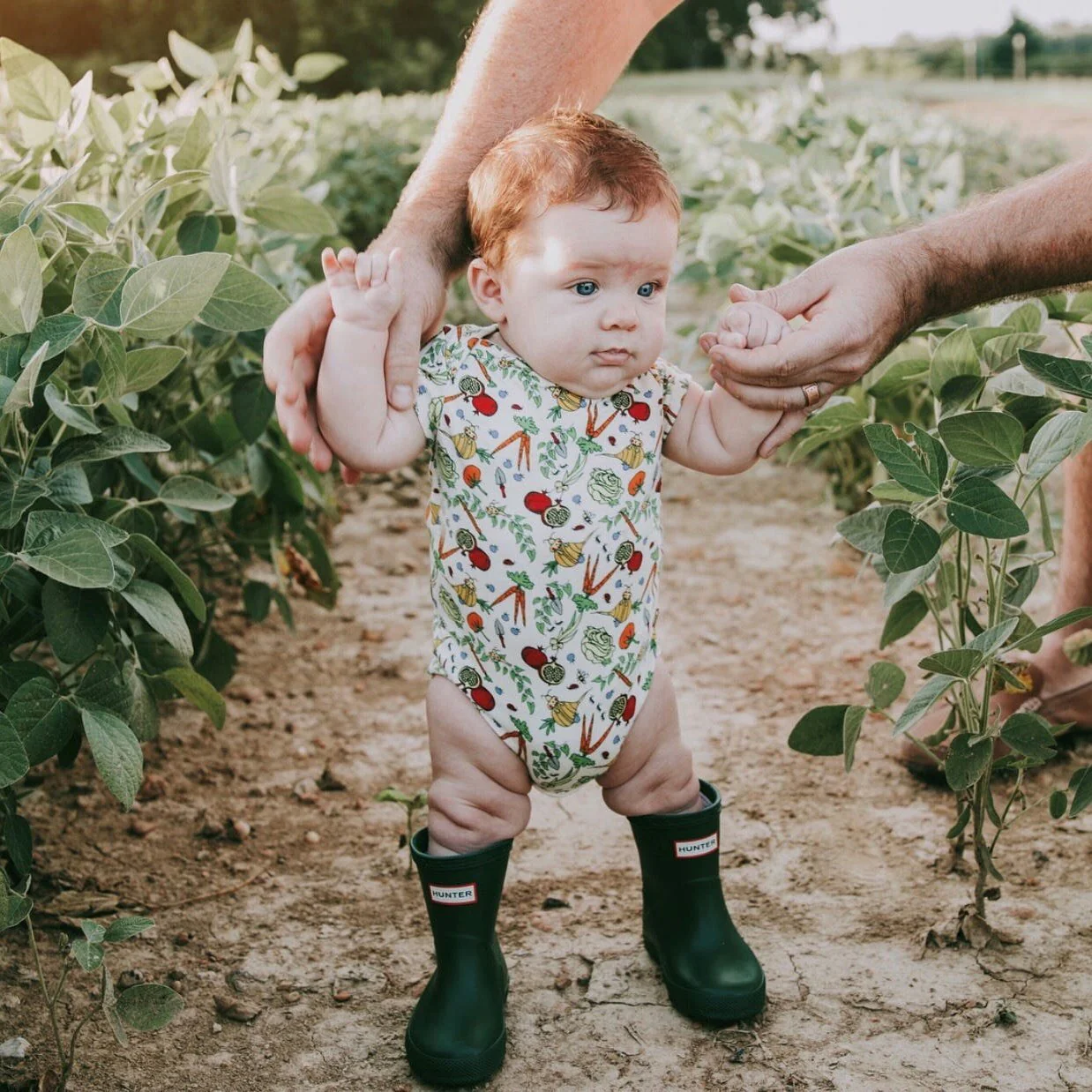 Baby wearing the Lucky Bug Veggie Garden Onesie
